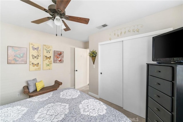 bedroom featuring a closet, visible vents, and a ceiling fan