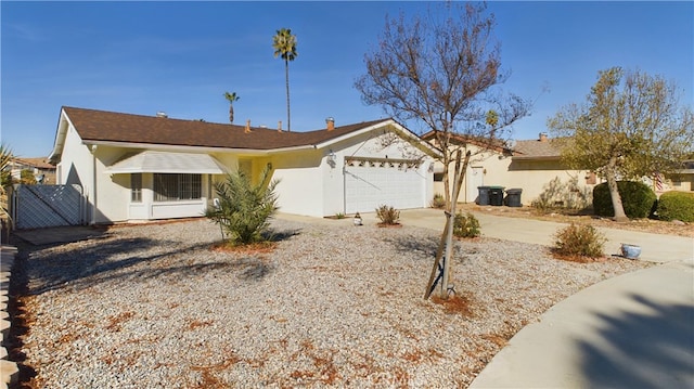 ranch-style house with concrete driveway, an attached garage, and stucco siding