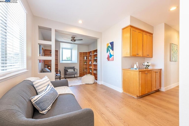 living room featuring ceiling fan and light hardwood / wood-style flooring