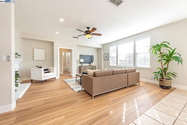 living room with ceiling fan and light hardwood / wood-style floors