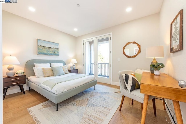 bedroom with access to exterior and light wood-type flooring