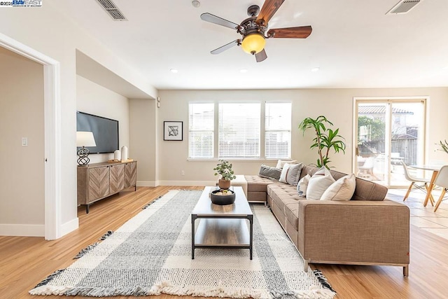 living room featuring ceiling fan and light wood-type flooring