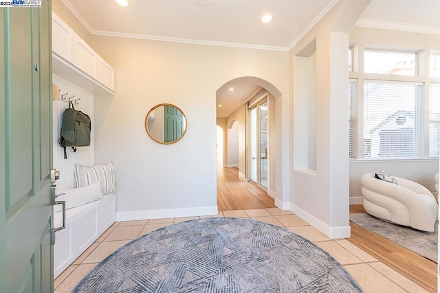 tiled foyer featuring ornamental molding