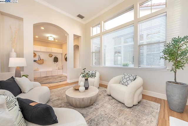 living room featuring crown molding and hardwood / wood-style floors