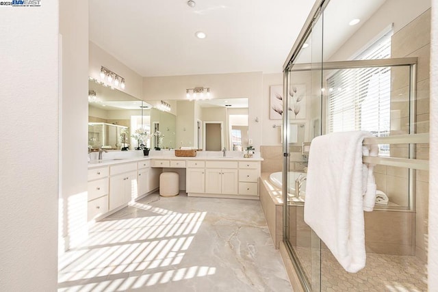 bathroom featuring vanity and separate shower and tub