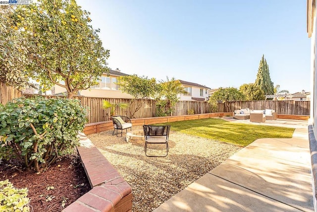 view of yard featuring an outdoor living space with a fire pit and a patio area