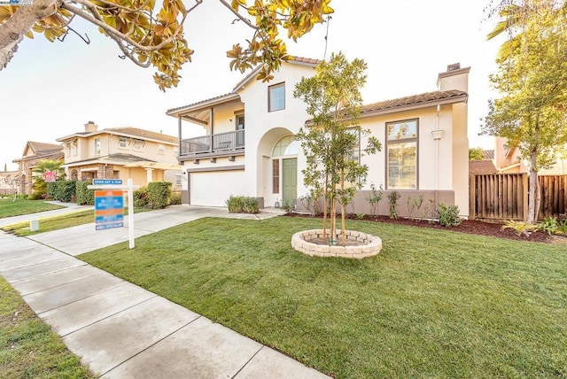 mediterranean / spanish-style home with a balcony, a garage, and a front yard