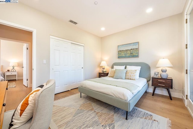 bedroom featuring a closet and light wood-type flooring