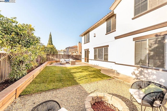 view of yard featuring a patio area and an outdoor living space with a fire pit