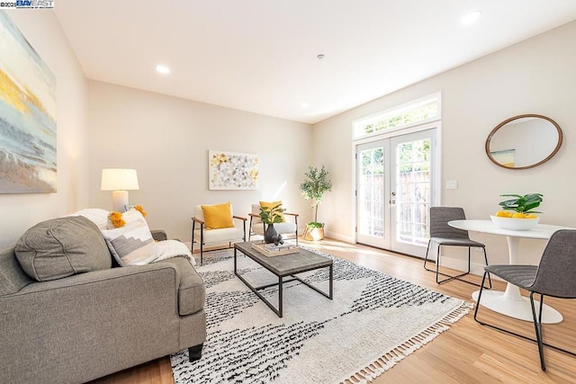 living room with hardwood / wood-style floors and french doors