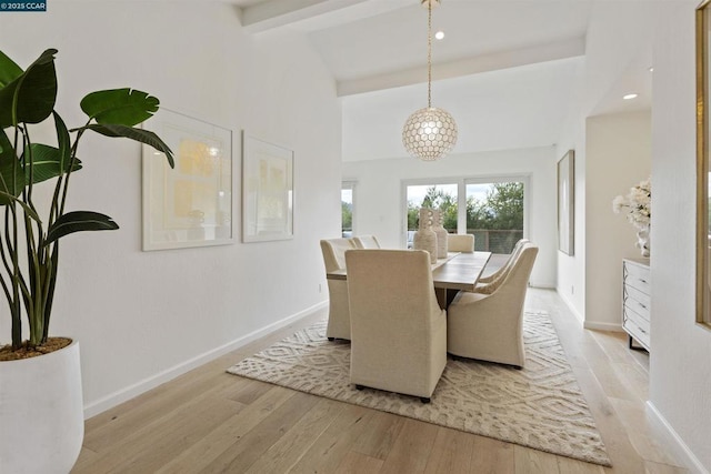 dining space with light hardwood / wood-style flooring, high vaulted ceiling, and beamed ceiling