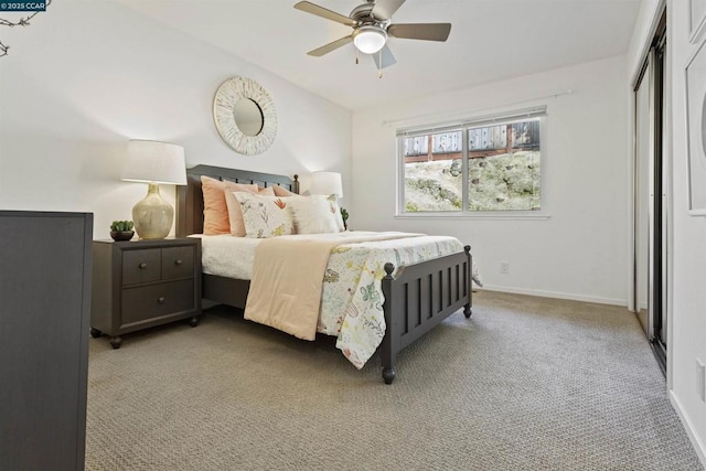 carpeted bedroom featuring ceiling fan and a closet