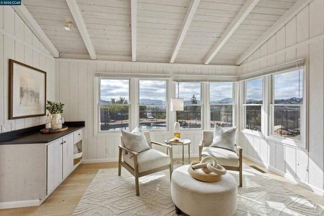 sunroom / solarium featuring lofted ceiling with beams and wood ceiling