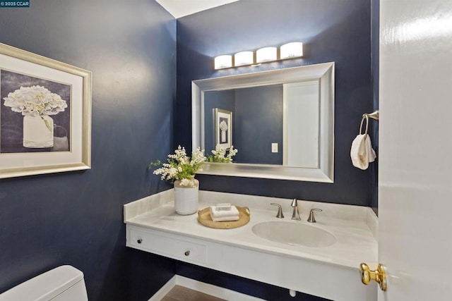 bathroom featuring vanity and toilet