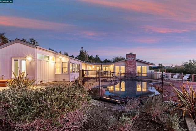 view of back house at dusk