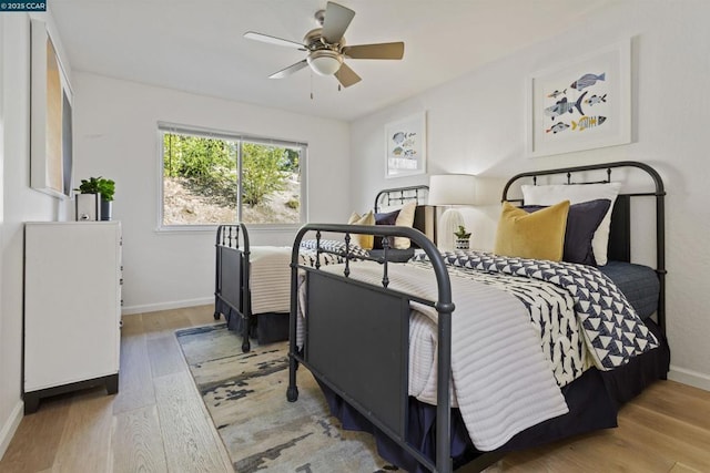 bedroom with ceiling fan and light hardwood / wood-style floors