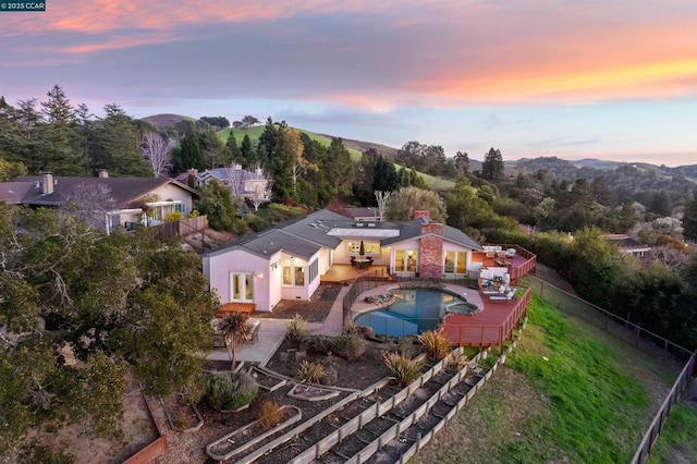 aerial view at dusk featuring a mountain view