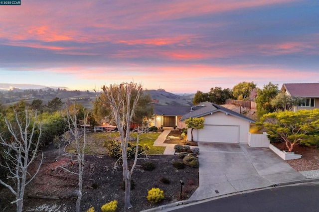 view of front of home with a garage and a mountain view