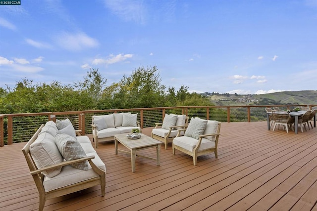 wooden terrace featuring outdoor lounge area and a mountain view