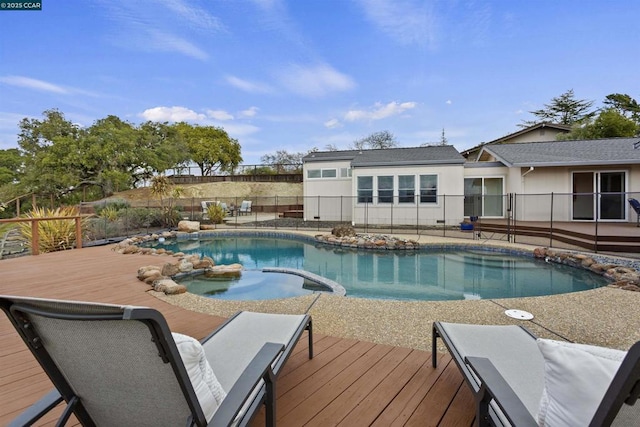 view of pool featuring a wooden deck and an in ground hot tub