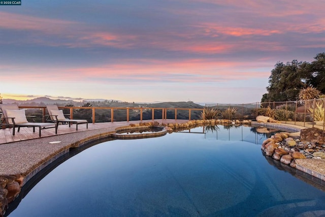 pool at dusk with a mountain view