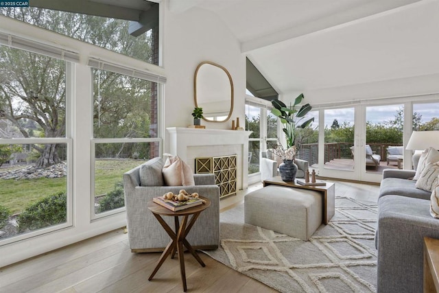 sunroom with vaulted ceiling with beams and a wealth of natural light