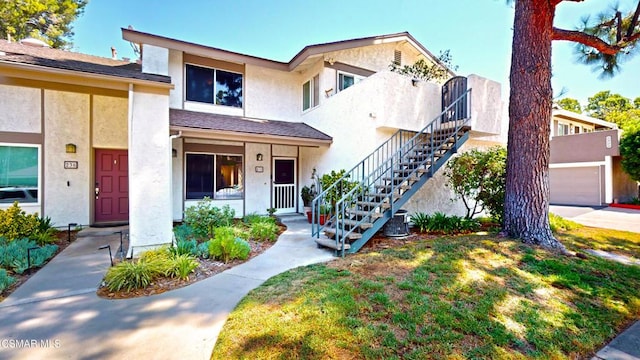 view of front of property with a garage and cooling unit