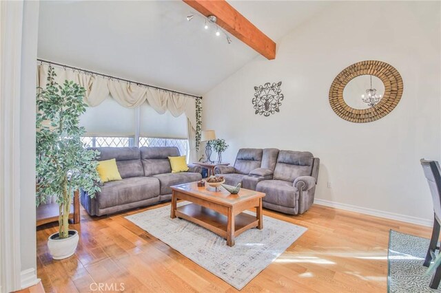 living room featuring wood-type flooring, a chandelier, and lofted ceiling with beams