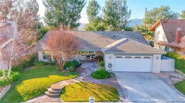 view of front of home featuring a garage and a front lawn