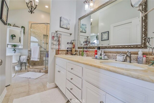 bathroom featuring lofted ceiling, vanity, walk in shower, toilet, and tile patterned floors