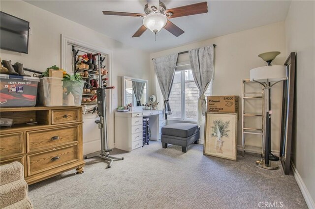 interior space with ceiling fan and carpet