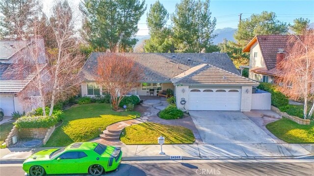 view of front of home featuring a garage and a front yard