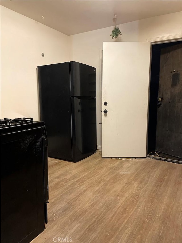 kitchen featuring light hardwood / wood-style flooring and black appliances