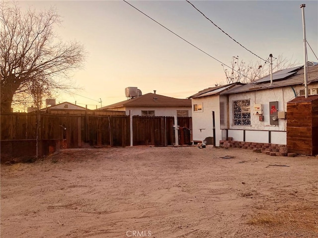 view of back house at dusk