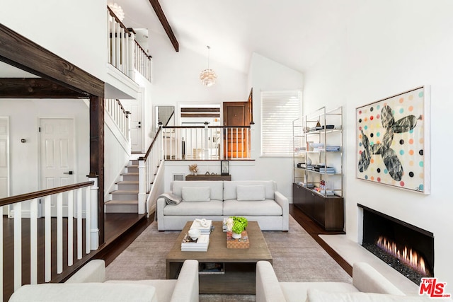 living room featuring high vaulted ceiling, hardwood / wood-style floors, and beam ceiling