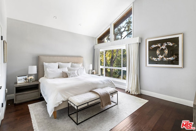 bedroom with high vaulted ceiling and dark hardwood / wood-style floors