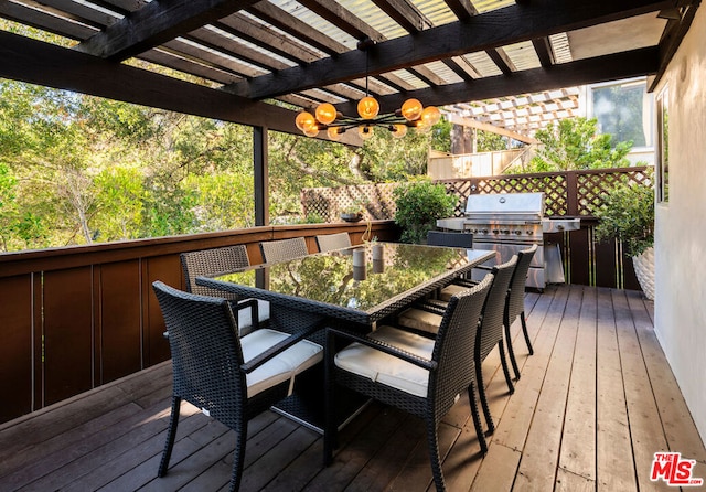 wooden terrace with area for grilling, grilling area, and a pergola