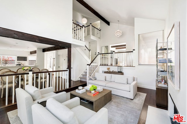 living room with beamed ceiling, wood-type flooring, and high vaulted ceiling