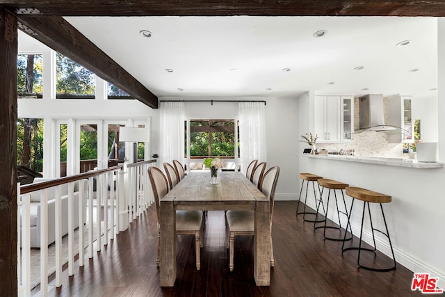 dining room featuring beam ceiling, dark hardwood / wood-style floors, and french doors