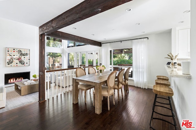 dining area with beamed ceiling and dark hardwood / wood-style floors