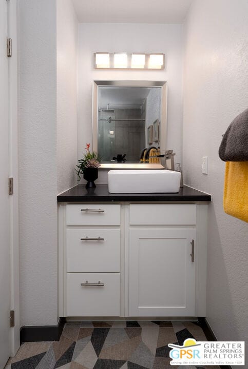 bathroom featuring vanity and a shower