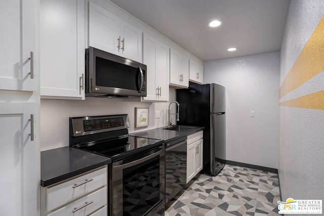 kitchen with sink, white cabinets, and appliances with stainless steel finishes