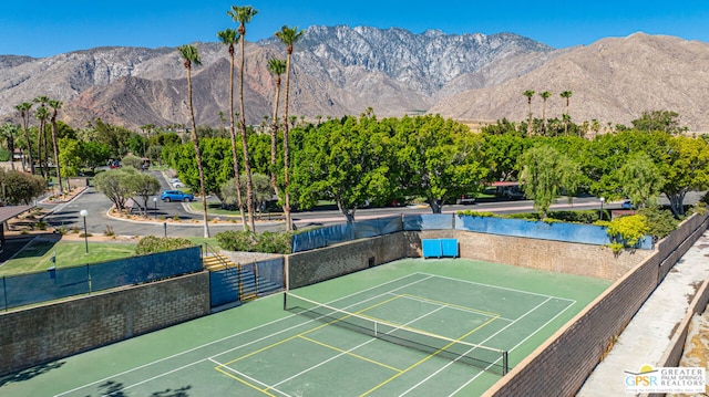 view of tennis court featuring a mountain view