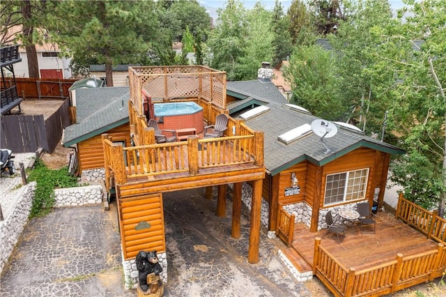 exterior space with a wooden deck and a hot tub