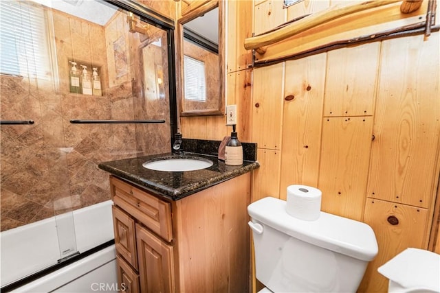 full bathroom featuring vanity, toilet, and combined bath / shower with glass door