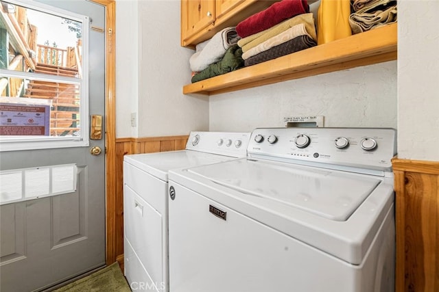 laundry room with cabinets, washer and dryer, and a wealth of natural light