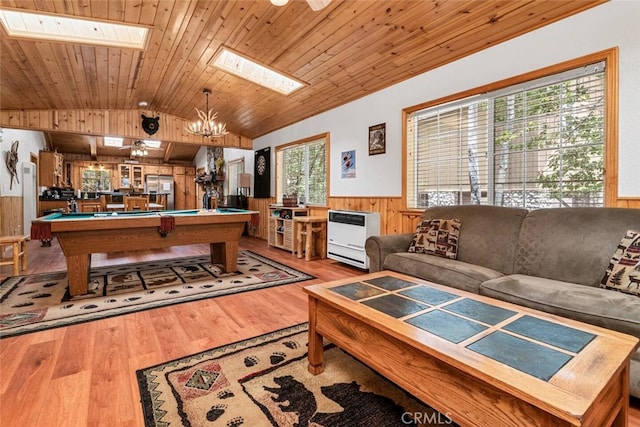 rec room featuring billiards, hardwood / wood-style floors, vaulted ceiling with skylight, heating unit, and wooden ceiling