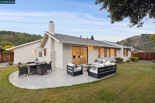 rear view of house with an outdoor living space, a yard, and a patio