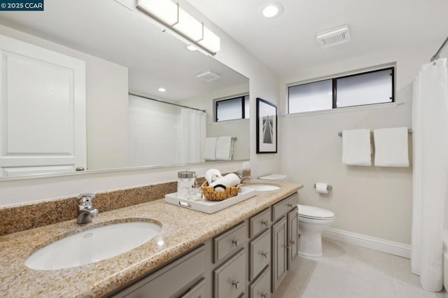 bathroom featuring tile patterned flooring, vanity, toilet, and walk in shower