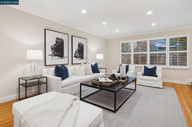 living room with crown molding and light hardwood / wood-style floors